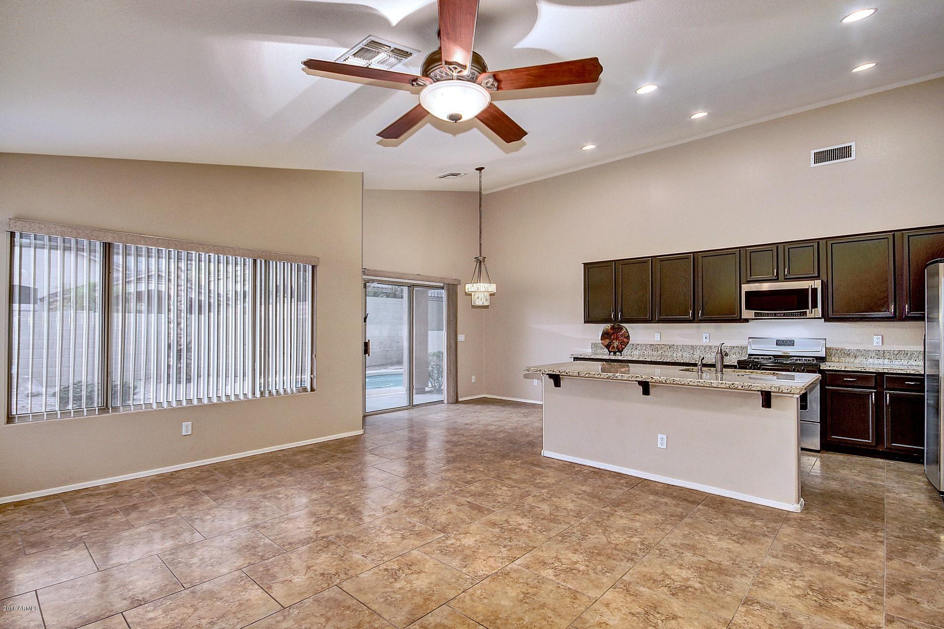 16056 South 18th Avenue Phoenix, AZ 85045 - Photo 10 of 37 a view of kitchen with microwave stove top oven and cabinets
