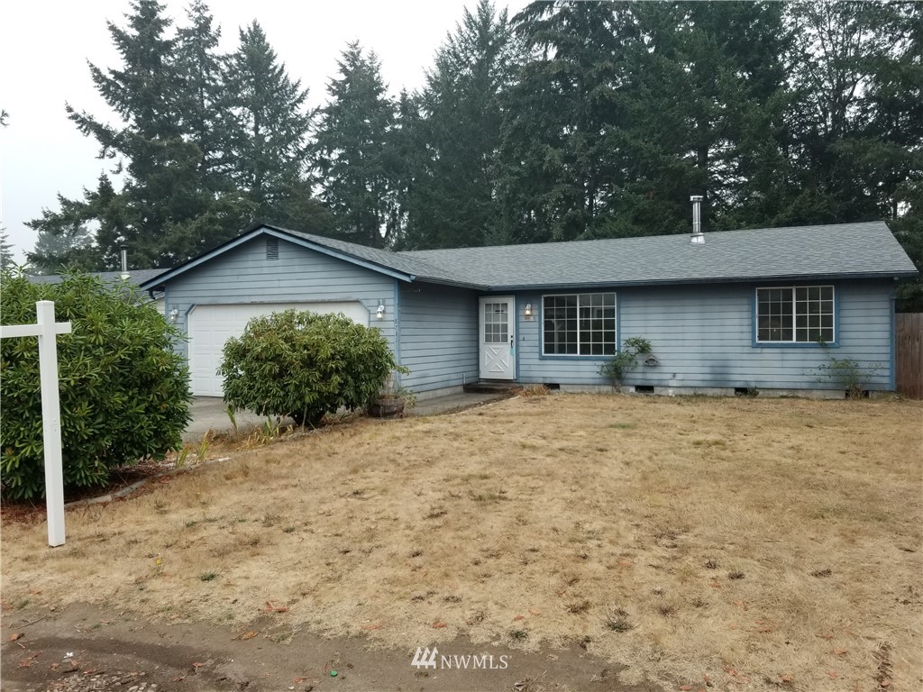 8731 Hawks Glen Loop Southeast Olympia, WA 98513 - Photo 1 of 15 a front view of a house with a yard and garage