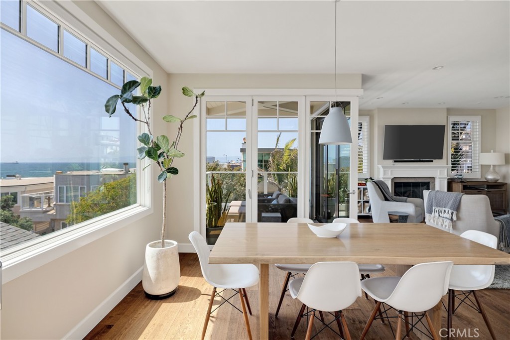 124 23rd Street Manhattan Beach, CA 90266 - Photo 25 of 46 a view of a dining room with furniture a chandelier and wooden floor
