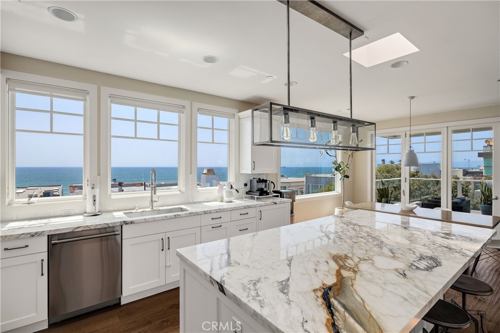 124 23rd Street Manhattan Beach, CA 90266 - Photo 4 of 46 a large kitchen with kitchen island a large counter space windows and appliances