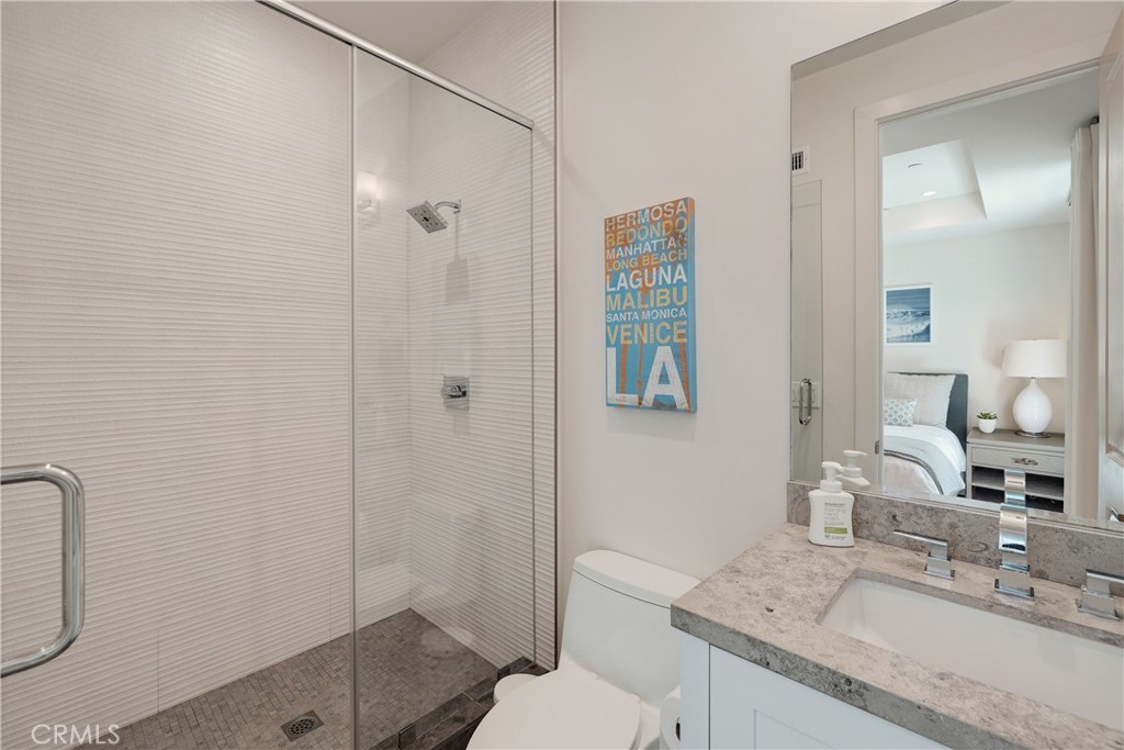 124 23rd Street Manhattan Beach, CA 90266 - Photo 44 of 46 a bathroom with a granite countertop sink a toilet and shower