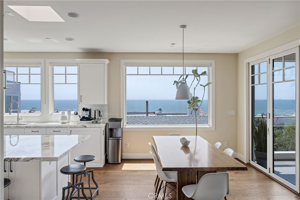 124 23rd Street Manhattan Beach, CA 90266 - Photo 6 of 46 a kitchen with kitchen island a large window and cabinets