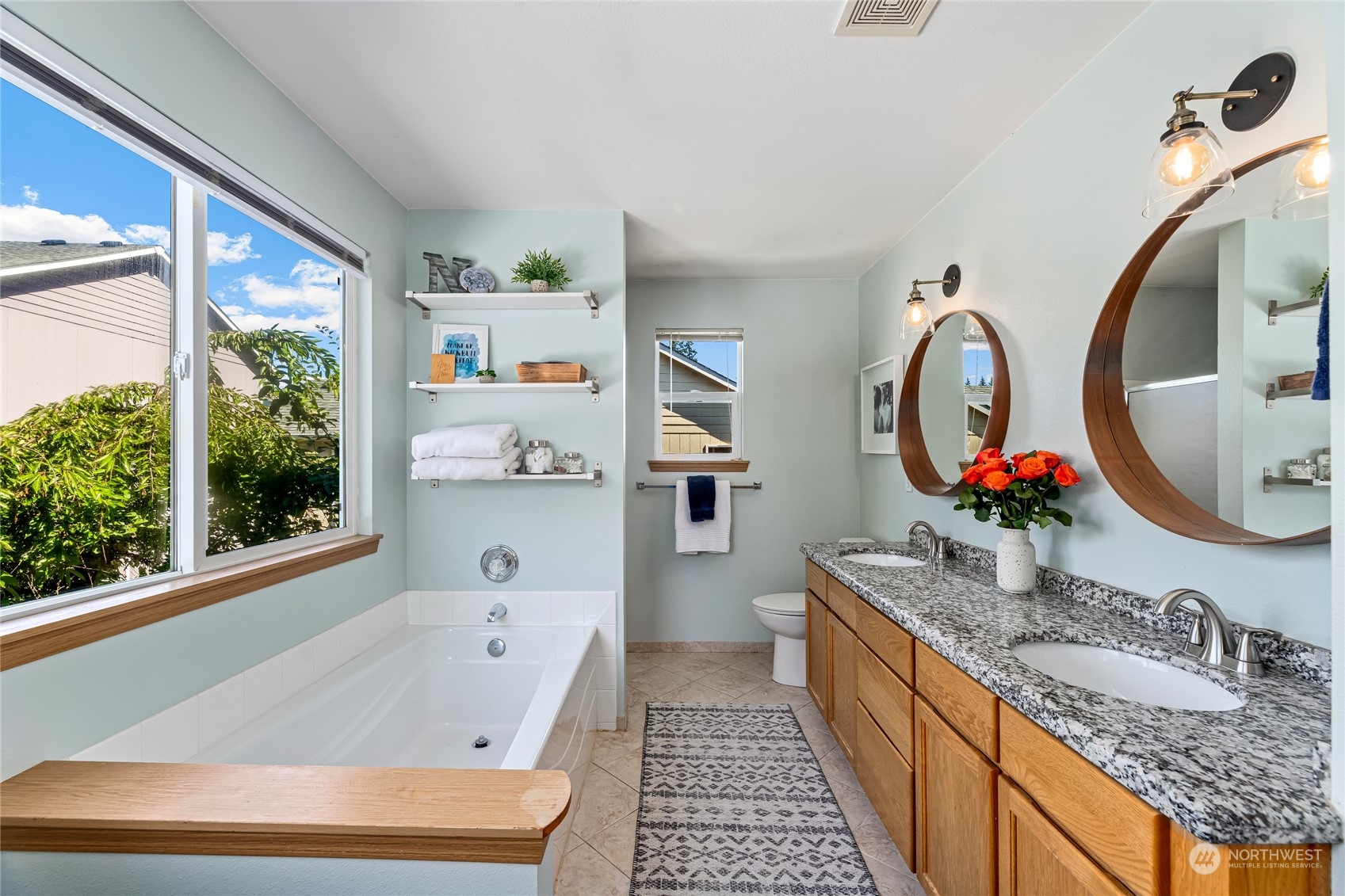 17716 8th Place West Bothell, WA 98012 - Photo 13 of 27 a bathroom with a granite countertop tub a double vanity sink and a mirror