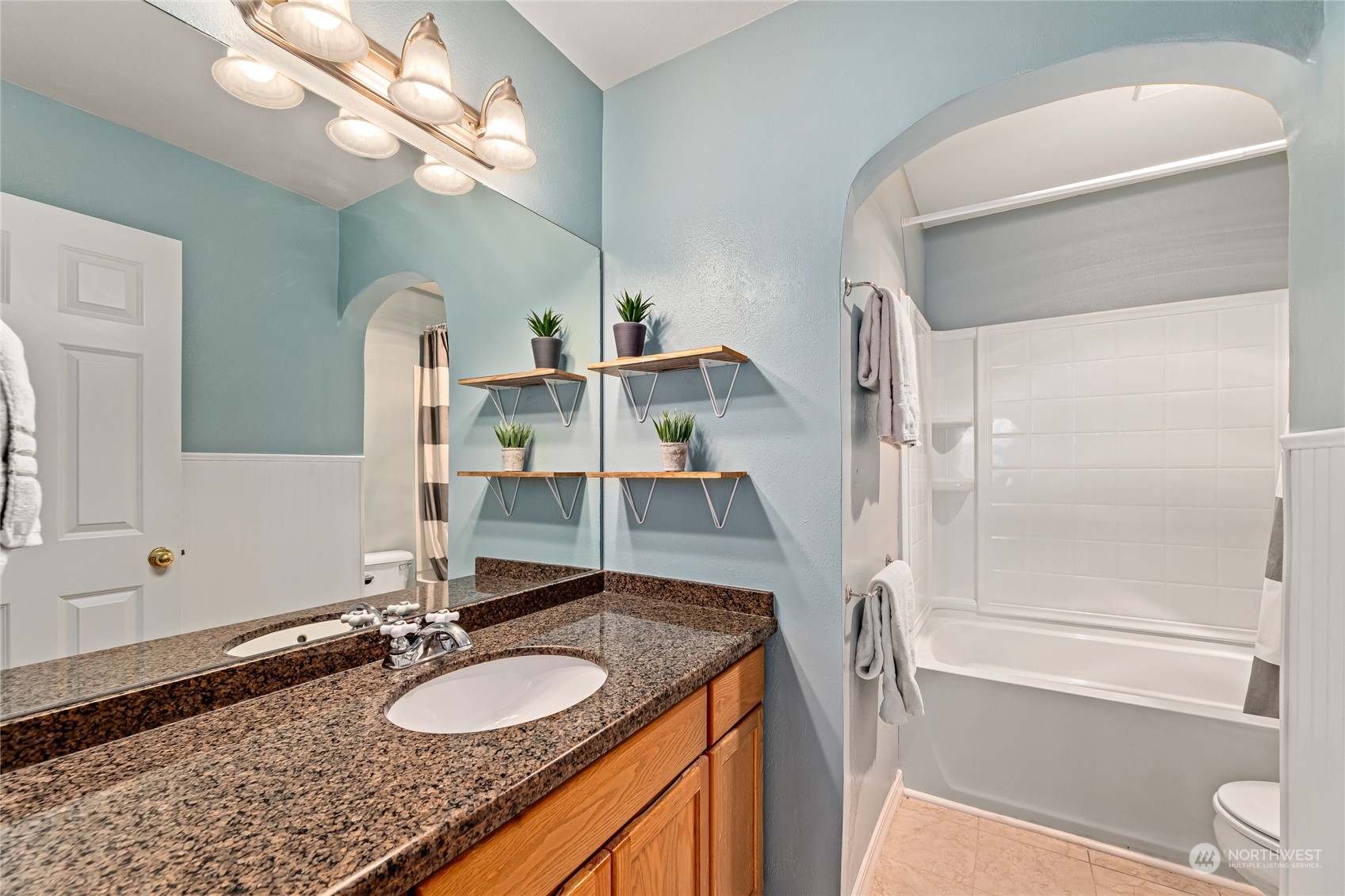 17716 8th Place West Bothell, WA 98012 - Photo 18 of 27 a bathroom with a granite countertop sink a toilet and a mirror