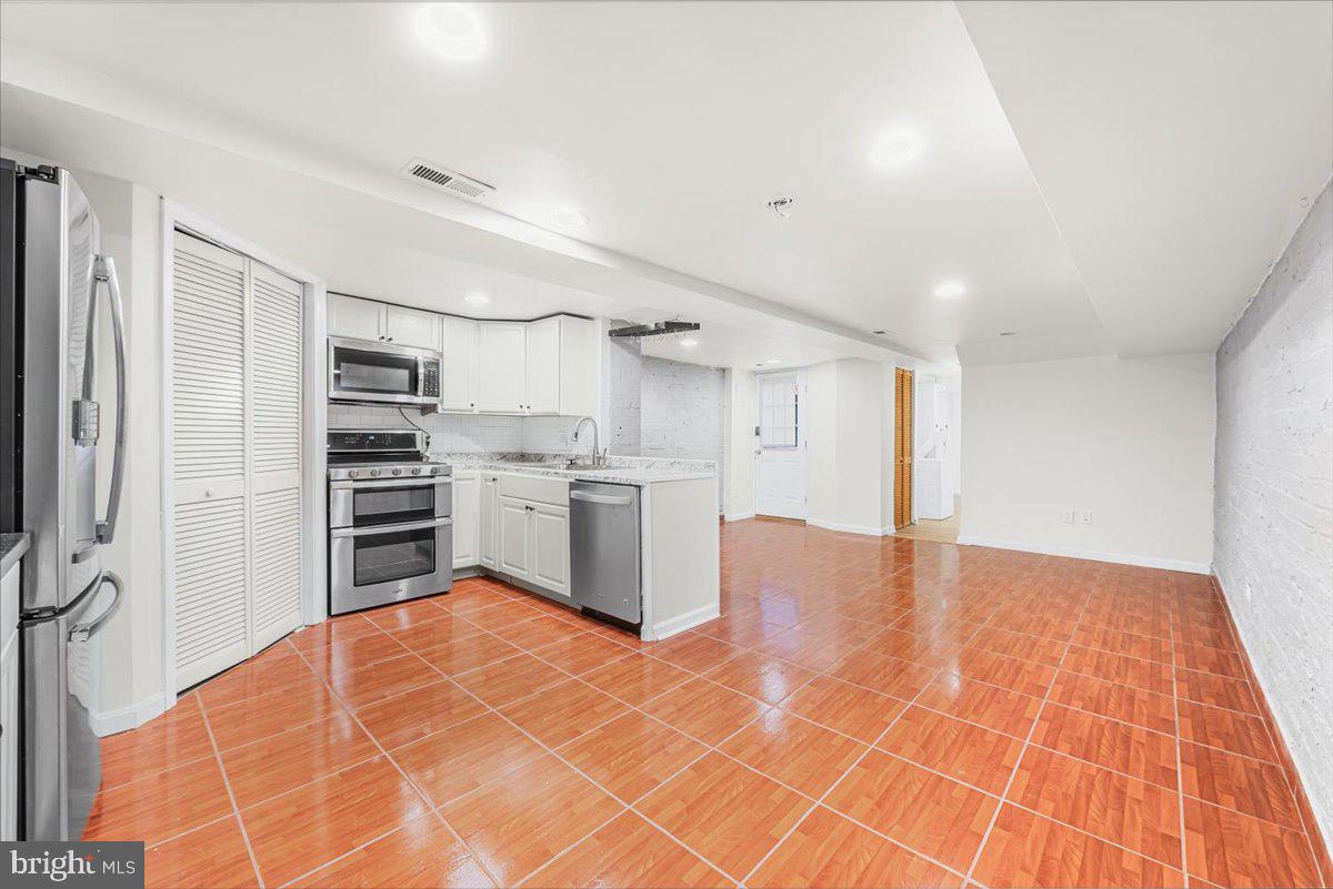 30 R Street Northeast, Unit B Washington, DC 20002 - Photo 9 of 21 a kitchen with stainless steel appliances a refrigerator and cabinets