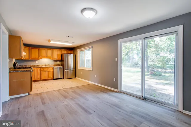 a view of a kitchen with wooden floor and a kitchen