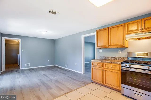 a kitchen with a stove a sink and a microwave