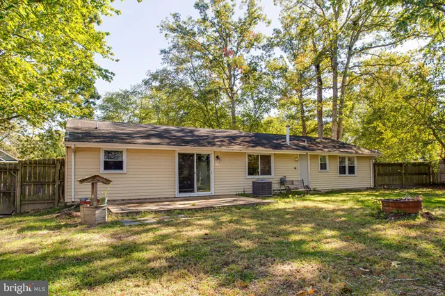 a view of a house with a yard patio and fire pit