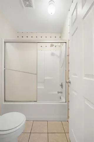 a bathroom with a bathtub a toilet and a shower