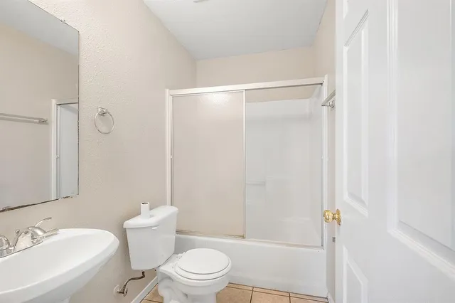 a white toilet sitting next to a bathroom sink