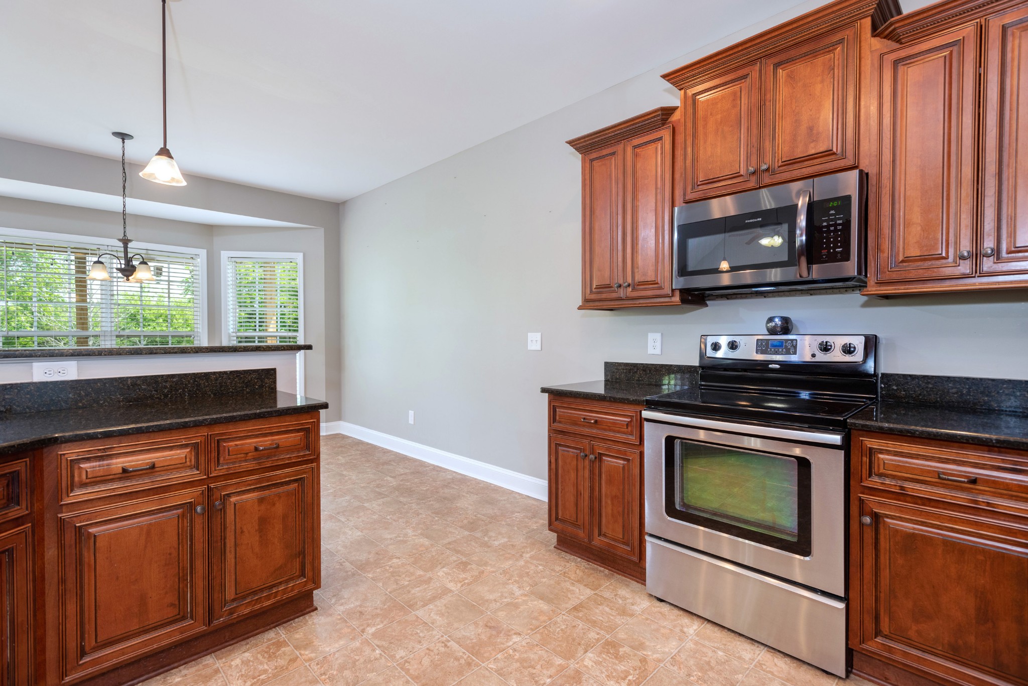 2024 Holloway Road Lebanon, TN 37090 - Photo 3 of 40 a kitchen with granite countertop a stove top oven microwave and cabinets