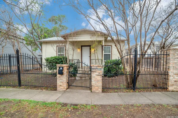 a front view of a house with a tree