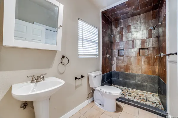a bathroom with a sink toilet and shower