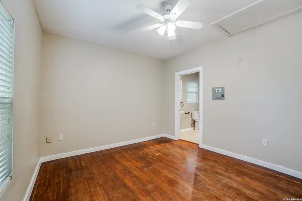 a view of empty room with wooden floor