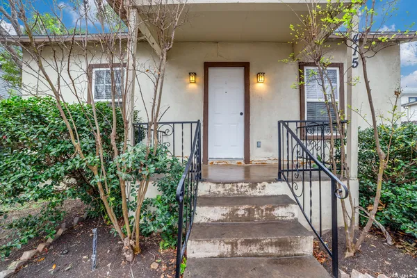 a view of balcony with lots of potted plants