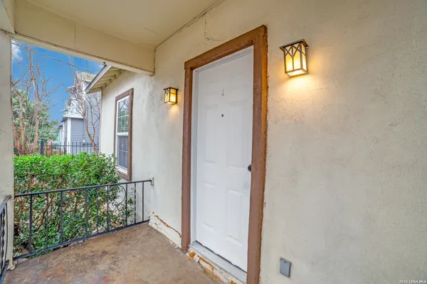 a view of a front door and wooden floor