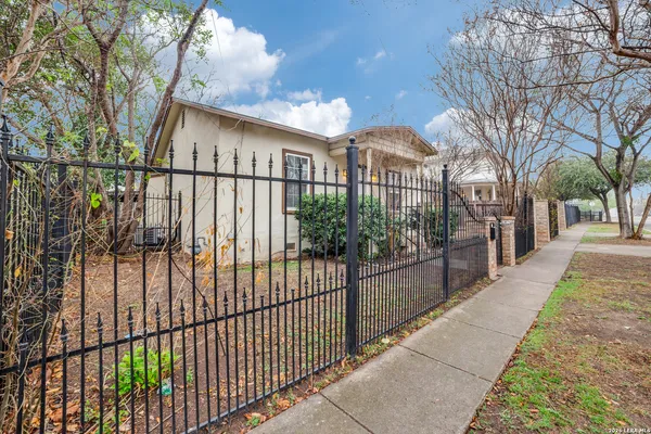 a view of a wrought iron fences in front of house
