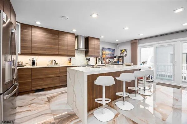 a kitchen with stainless steel appliances kitchen island granite countertop a sink and cabinets