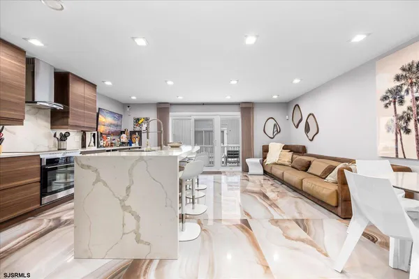 a living room with furniture and kitchen view