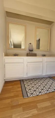 a bathroom with a sink vanity and mirror