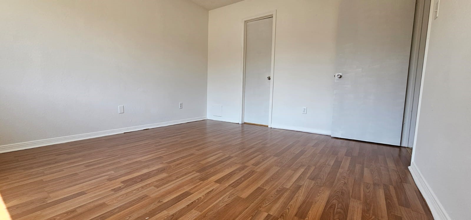 11841 Spring Grove Drive Houston, TX 77099 - Photo 16 of 28 a view of an empty room with wooden floor
