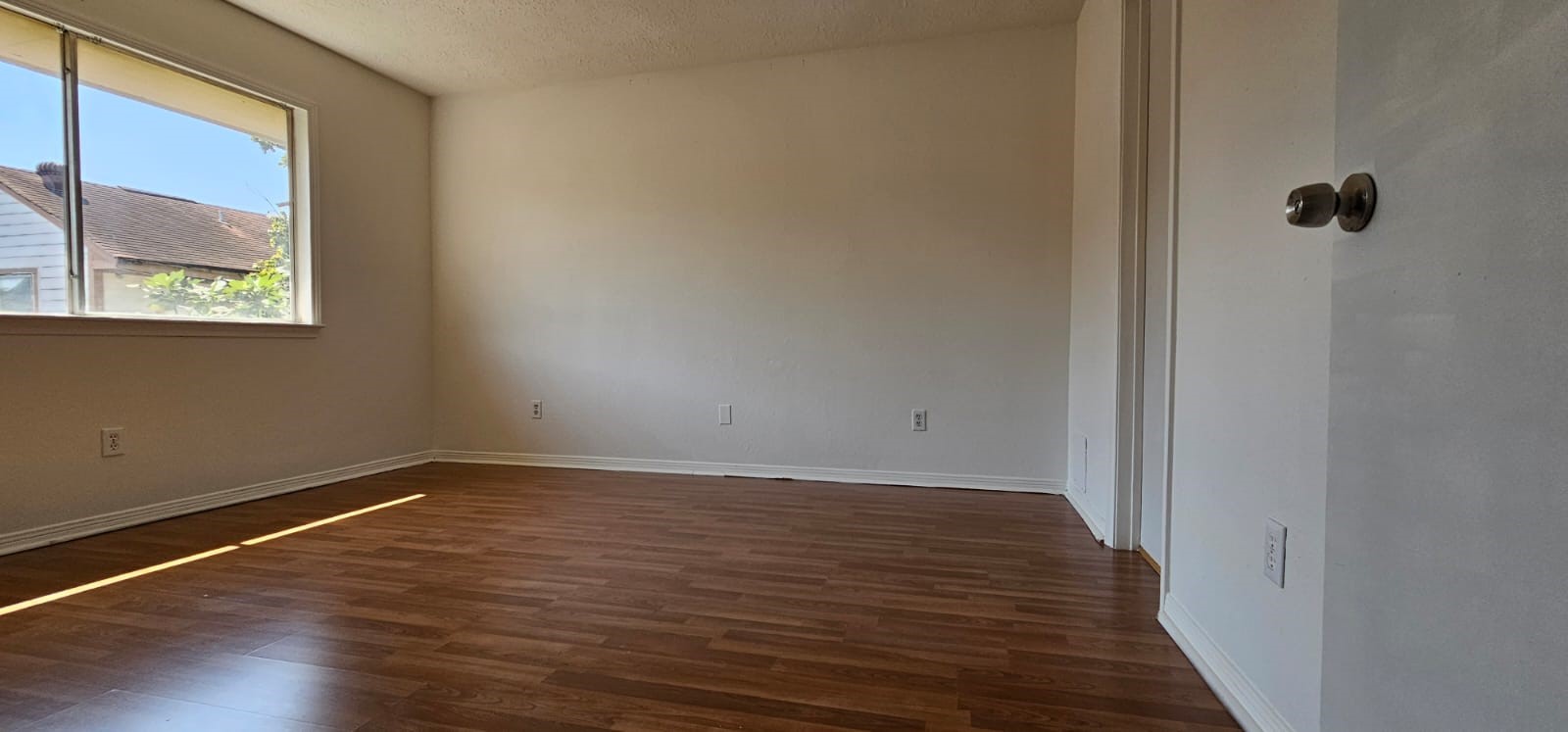 11841 Spring Grove Drive Houston, TX 77099 - Photo 18 of 28 a view of an empty room with wooden floor and a window