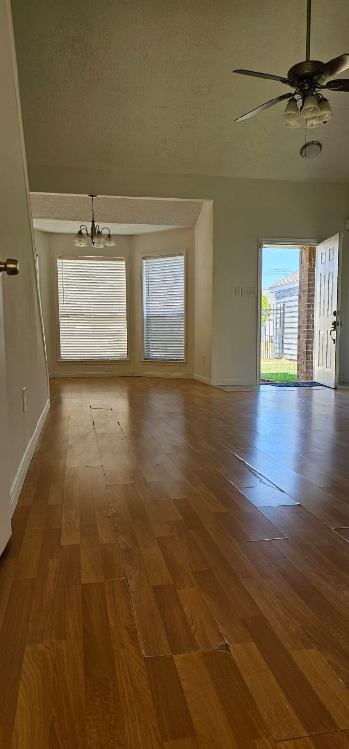 11841 Spring Grove Drive Houston, TX 77099 - Photo 23 of 28 an empty room with wooden floor and windows