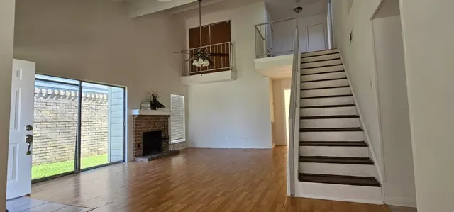 a view of a kitchen with wooden floor and stairs