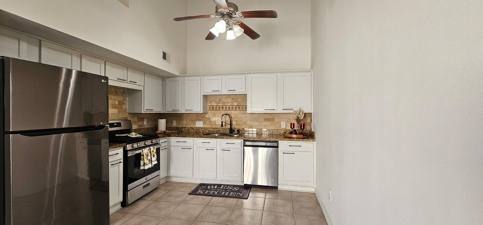 11841 Spring Grove Drive Houston, TX 77099 - Photo 7 of 28 a kitchen with stainless steel appliances a refrigerator a sink a stove a microwave and island