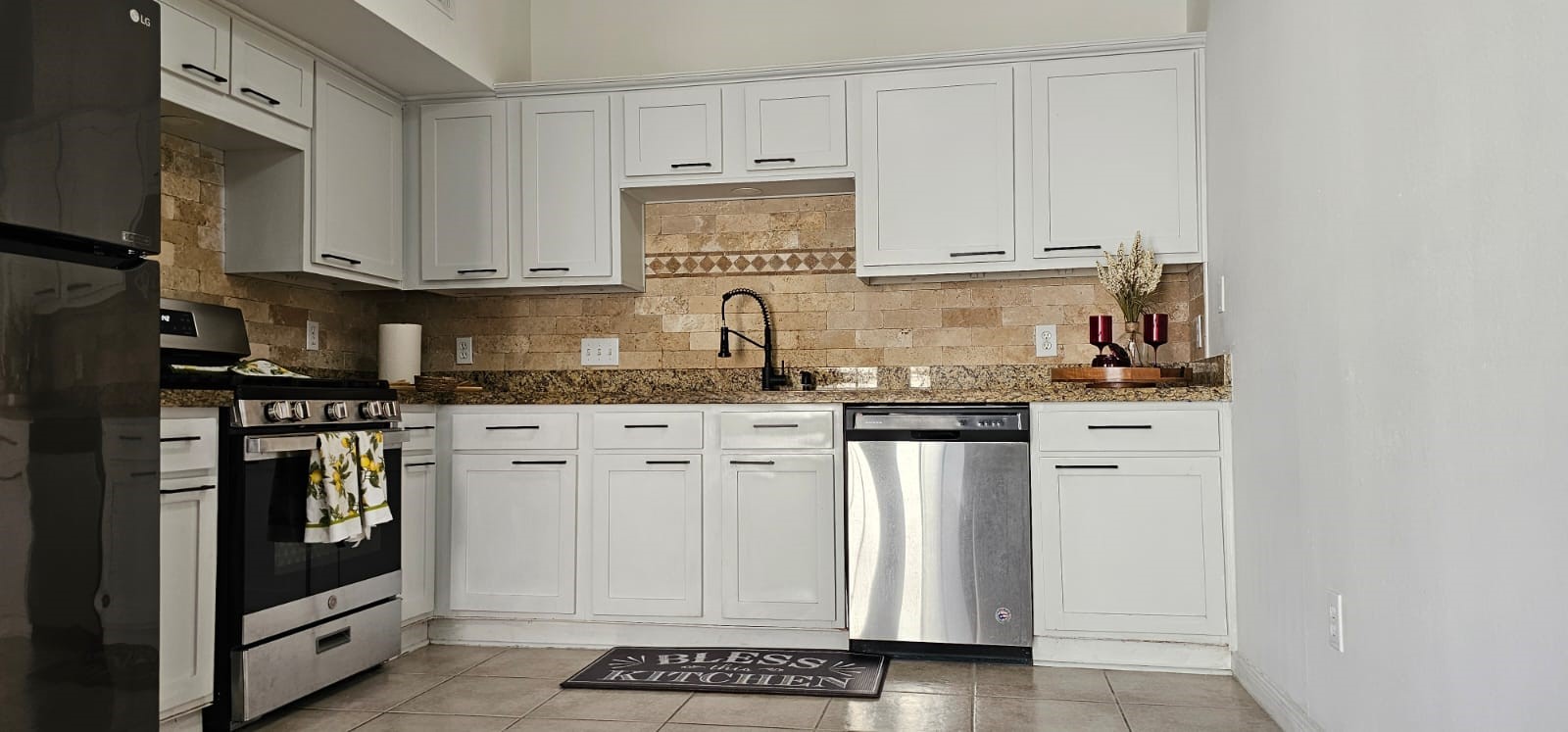 11841 Spring Grove Drive Houston, TX 77099 - Photo 8 of 28 a kitchen with granite countertop white cabinets and stainless steel appliances