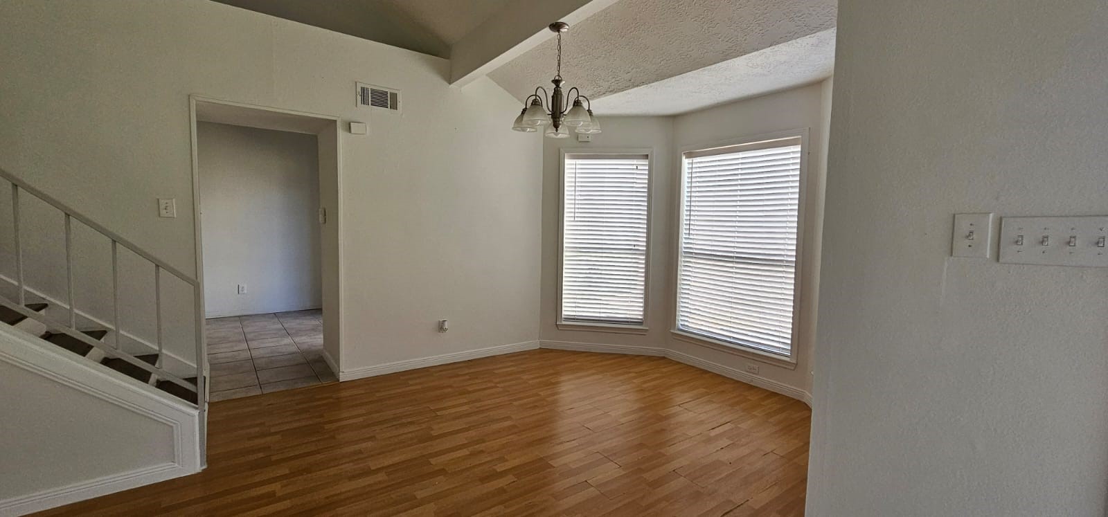 11841 Spring Grove Drive Houston, TX 77099 - Photo 9 of 28 a view of an empty room with a window and wooden floor