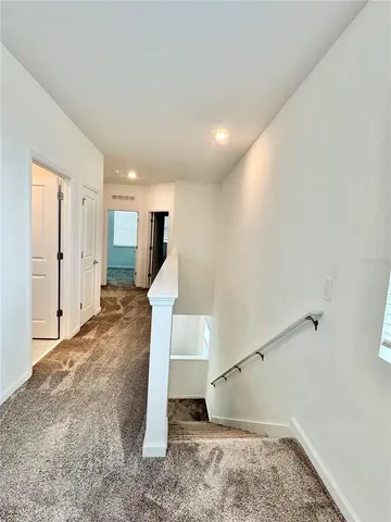 a view of a room with stairs and wooden floor