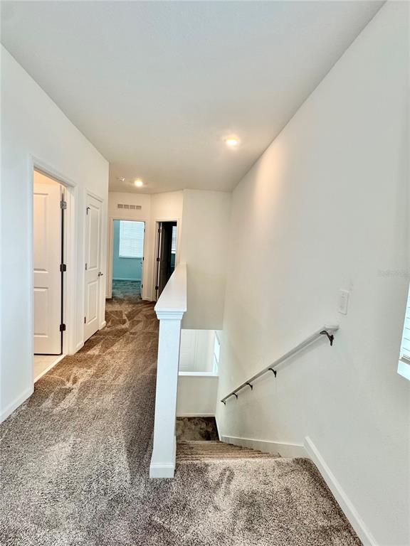 6473 Pine Warbler Way St. Cloud, FL 34771 - Photo 12 of 27 a view of a room with stairs and wooden floor