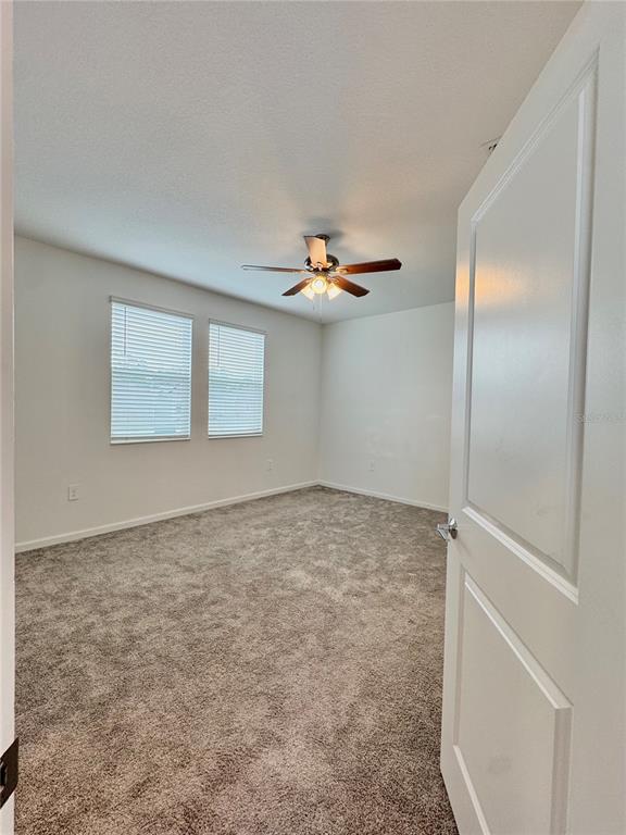 6473 Pine Warbler Way St. Cloud, FL 34771 - Photo 13 of 27 wooden floor in an empty room