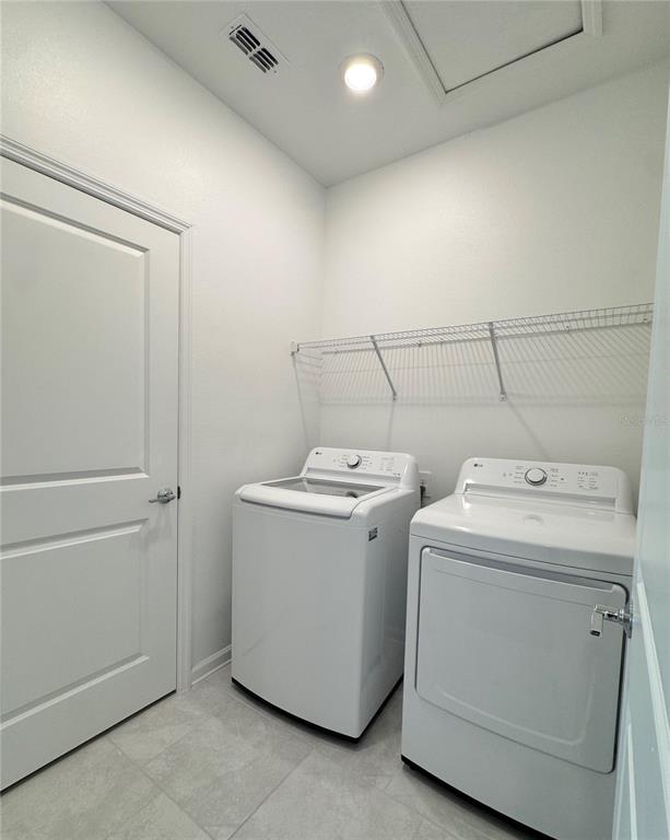 6473 Pine Warbler Way St. Cloud, FL 34771 - Photo 20 of 27 a utility room with dryer and washer
