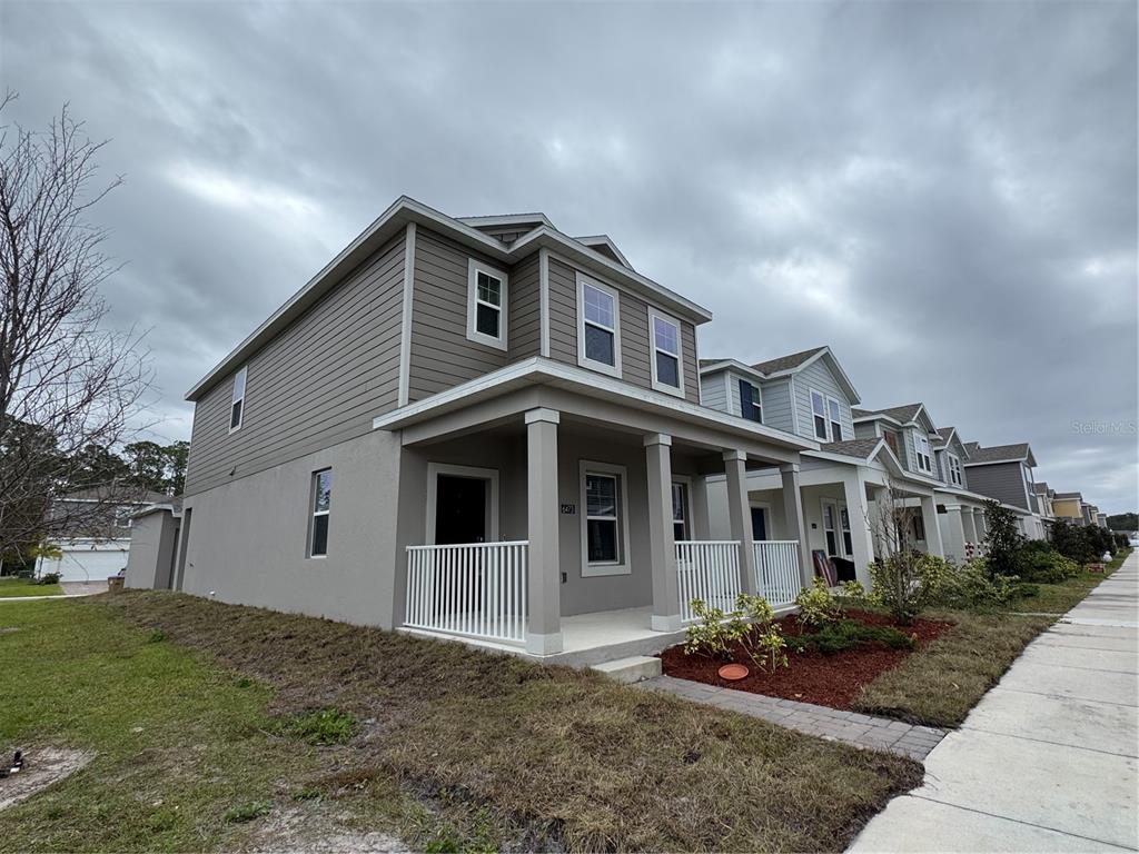 6473 Pine Warbler Way St. Cloud, FL 34771 - Photo 21 of 27 a front view of a house with garden