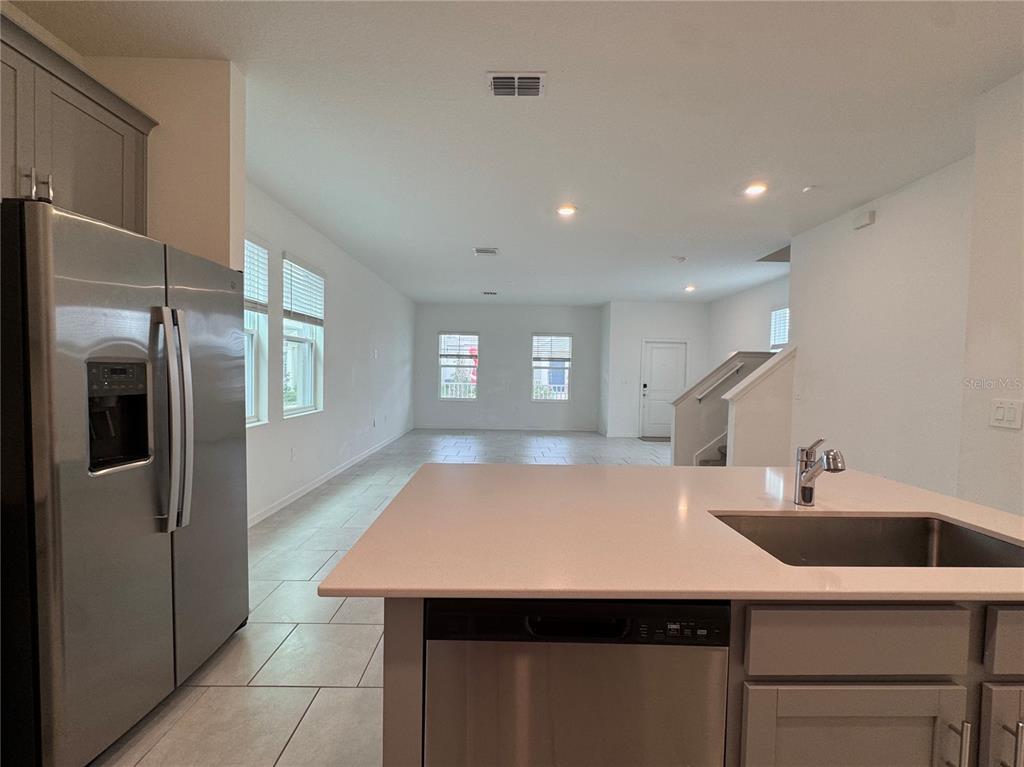 6473 Pine Warbler Way St. Cloud, FL 34771 - Photo 4 of 27 a kitchen with stainless steel appliances a sink a refrigerator and window