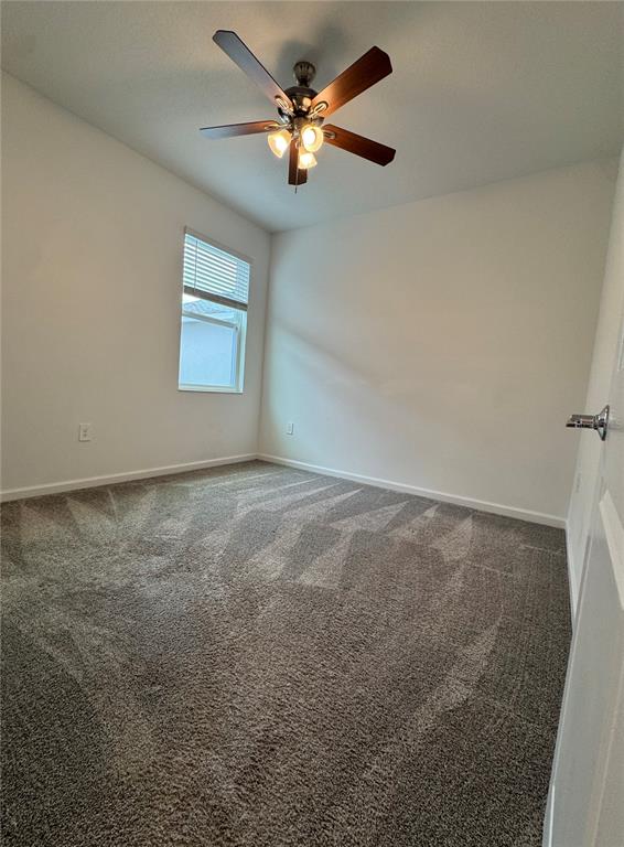 6473 Pine Warbler Way St. Cloud, FL 34771 - Photo 9 of 27 an empty room with a window and a fan