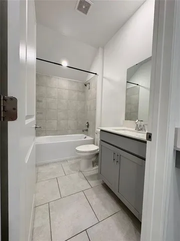 a bathroom with a double vanity sink toilet and shower
