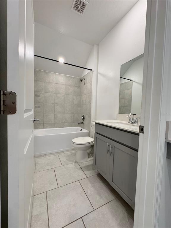 6473 Pine Warbler Way St. Cloud, FL 34771 - Photo 10 of 27 a bathroom with a double vanity sink toilet and shower
