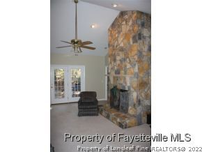 1550 Reservation Road Aberdeen, NC 28315 - Photo 2 of 7 a view of a living room with a table and a chandelier
