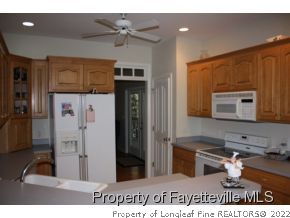 1550 Reservation Road Aberdeen, NC 28315 - Photo 3 of 7 a kitchen with stainless steel appliances kitchen island granite countertop a refrigerator and a sink