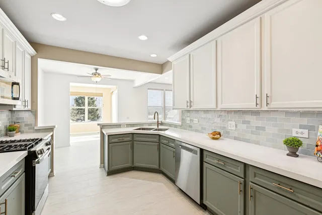 a kitchen with a sink stove and cabinets