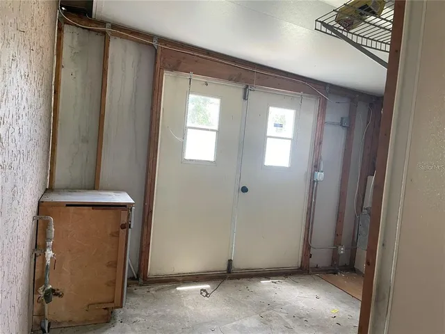 a view of a door and closet in a room