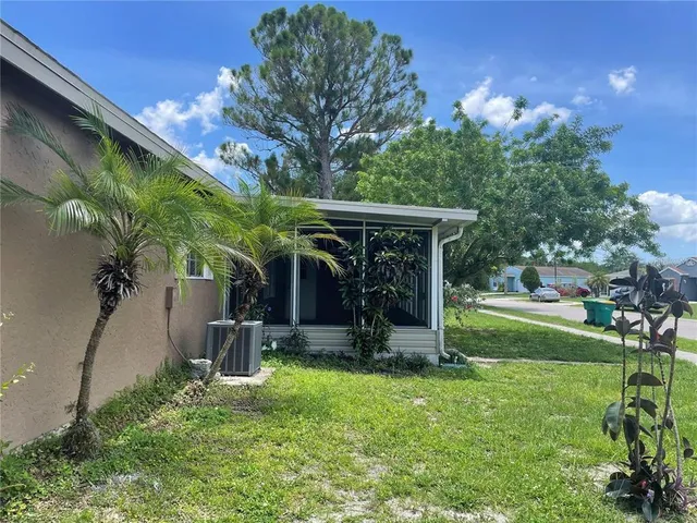 a view of a backyard with plants and a patio