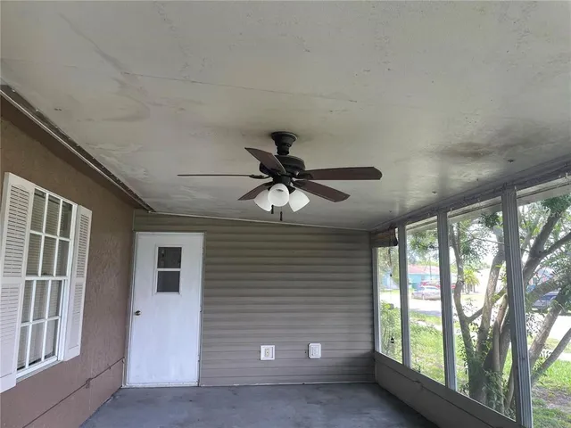 a view of a livingroom with a ceiling fan and window