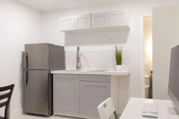 a kitchen with a refrigerator and a sink