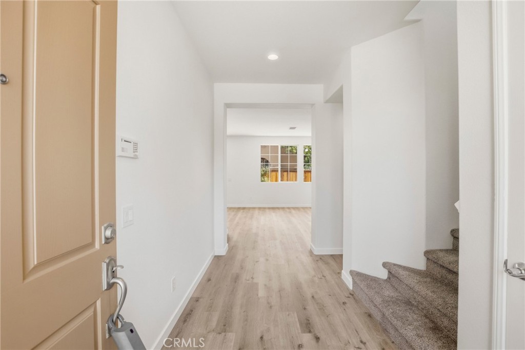 31598-31598 Six Rivers Court Temecula, CA 92592 - Photo 11 of 43 a view of a hallway with wooden floor and a bathroom