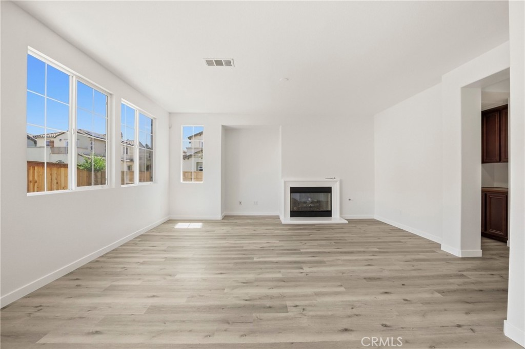 31598-31598 Six Rivers Court Temecula, CA 92592 - Photo 13 of 43 a view of an empty room with window and wooden floor