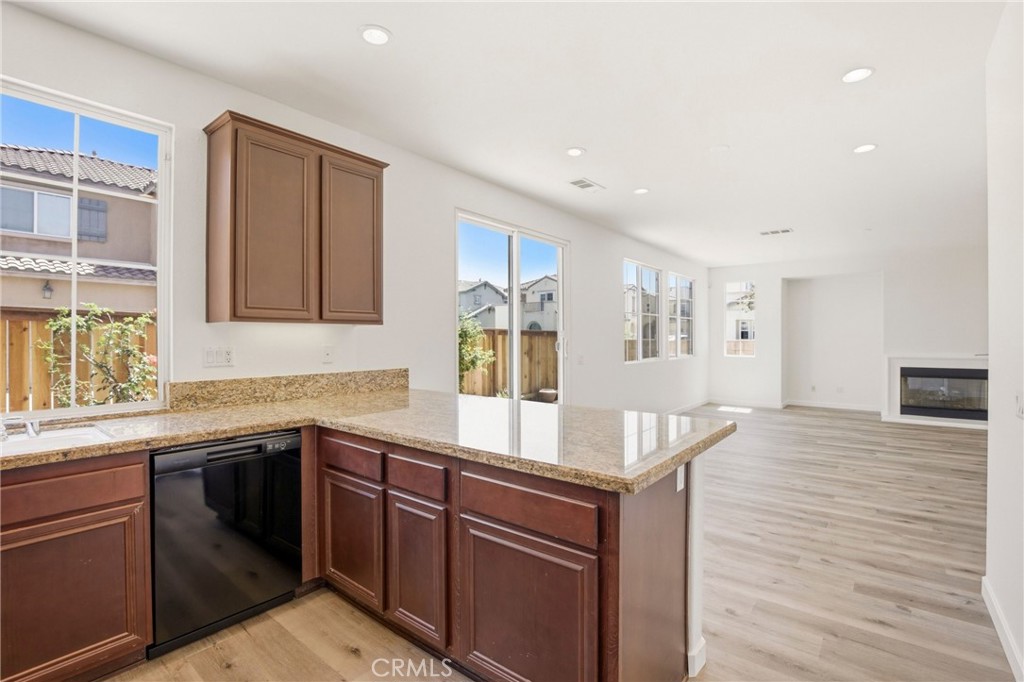 31598-31598 Six Rivers Court Temecula, CA 92592 - Photo 19 of 43 a kitchen with a sink cabinets and wooden floor